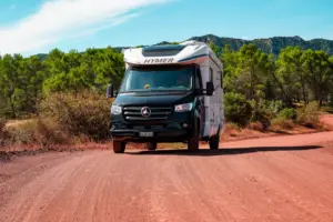 Die rötliche Erde beim Lac de Salagou erinnert an Bilder aus Australien und das heranfahrende Wohnmobil sieht aus als würde es durch die australische Steppe fahren.