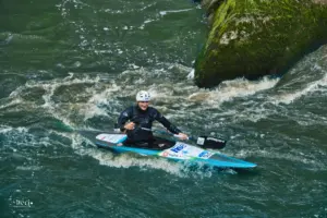 Der Kayak Fahrer in einer Wasserschnelle des Wildbaches.